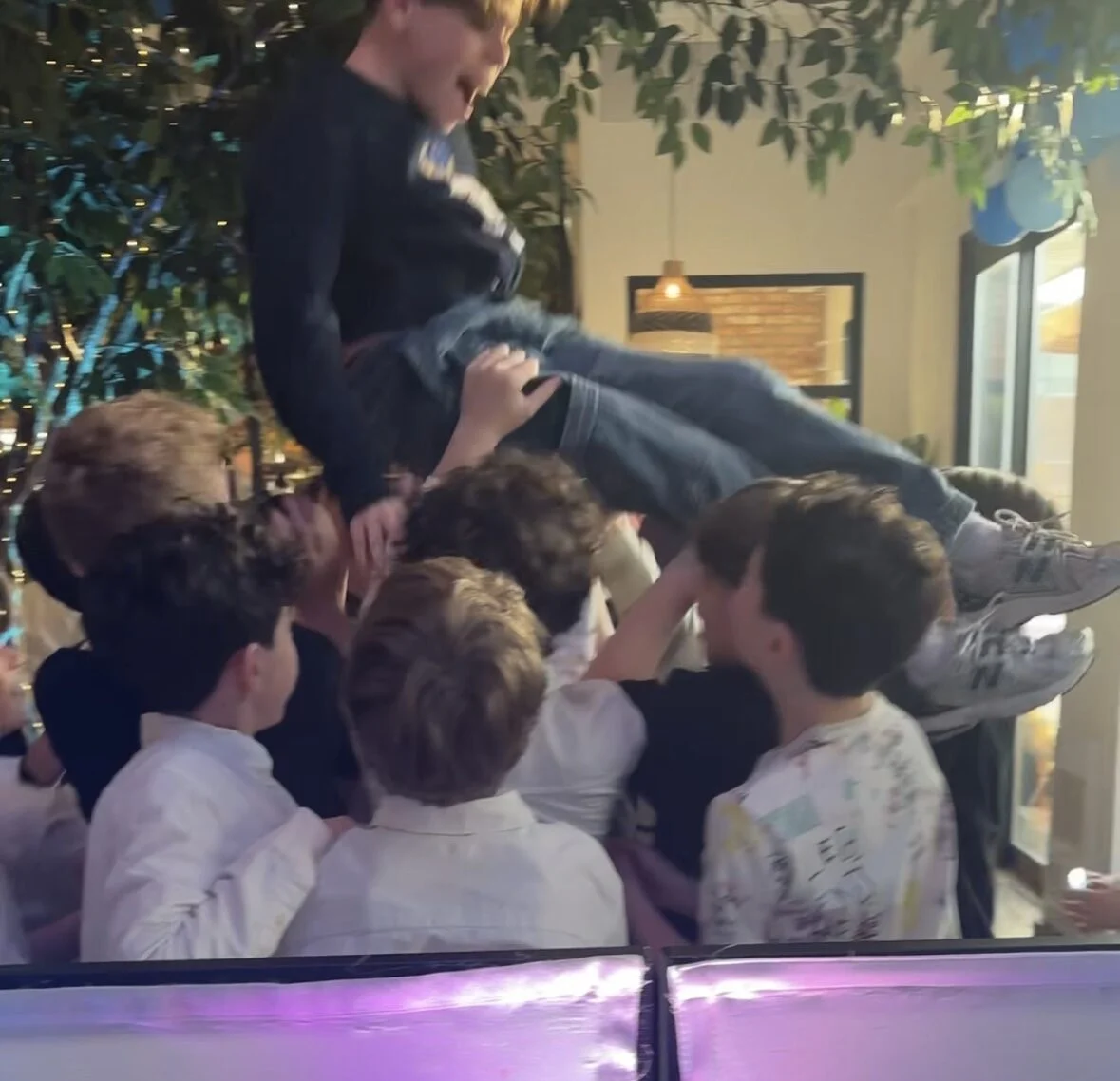 Guests dancing under event lighting